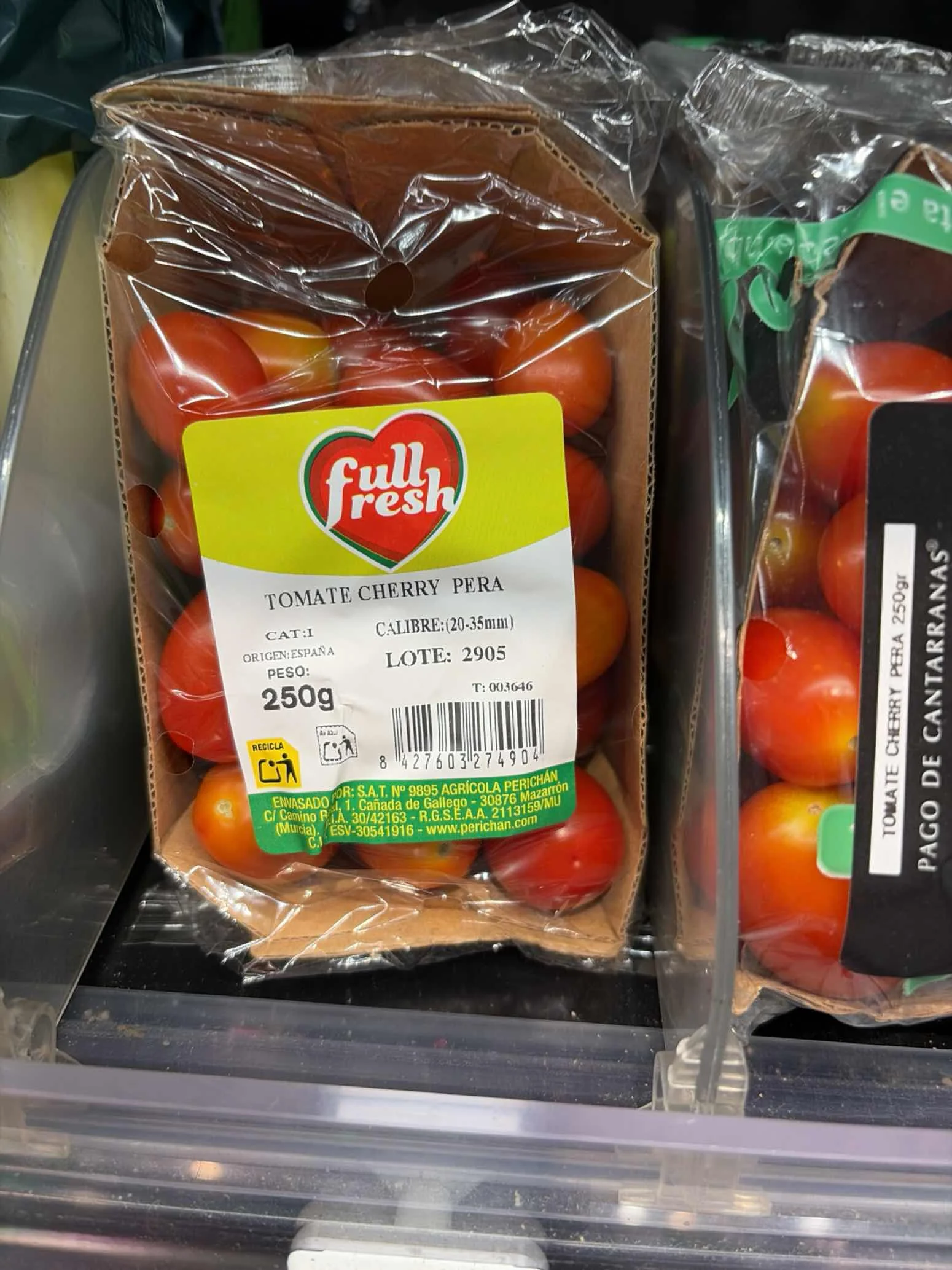 Packaged cherry pear tomatoes on a retail shelf